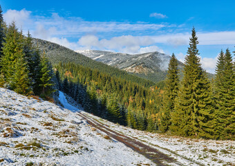 Fototapeta na wymiar Autumn Serenity: Snow-Kissed Mountain Trail