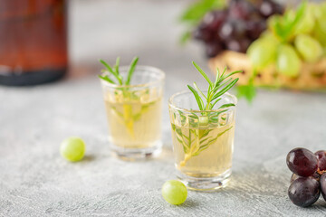 Traditional Georgian  chacha, also known as grape vodka or Georgian grappa in shot glasses  and fresh grapes