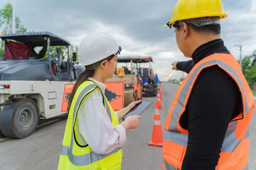 Female civil engineers consult with or with contractors to build rural roads using online technology.