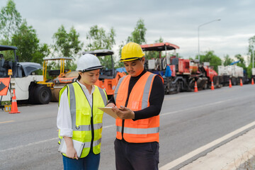 Female civil engineers consult with or with contractors to build rural roads using online technology.