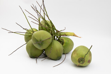 Big amount of coconut bunches with green shell color on isolated white background.