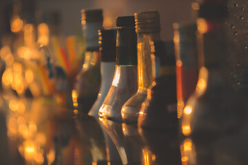 Alcoholic bottles in bar on glass table