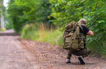A lightly armed fighter looks into the sight along the road