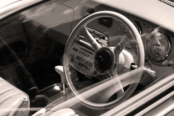 Steering wheel and dashboard of a retro car. Close-up.