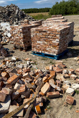 Recycling of old red bricks. Concrete debris and bricks piled ready to sell