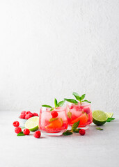 Fototapeta na wymiar Refreshing Cold Cocktail or Mocktail with Berries and Lime, Raspberry Lemonade