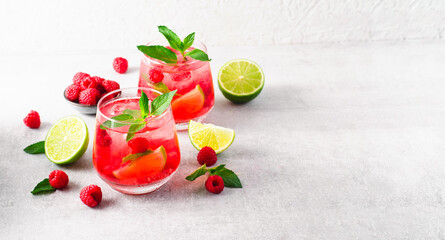 Refreshing Cold Cocktail or Mocktail with Berries and Lime, Raspberry Lemonade