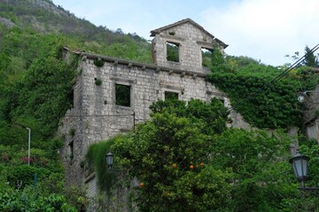 Fototapeta na wymiar Ruined building in Perast by Bay of Kotor in Montenegro. Perast is historic city on the Unesco list.