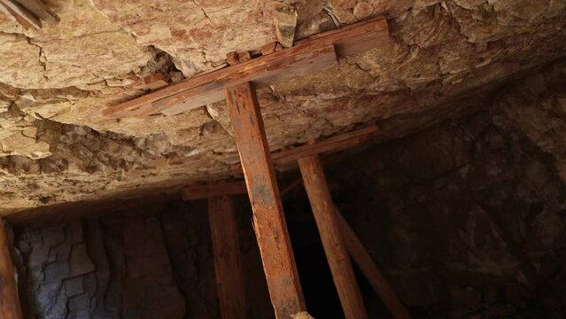 Wood Stulls Holding Up Ceiling from Inside Abandoned Mine - Shallow Depth of Field