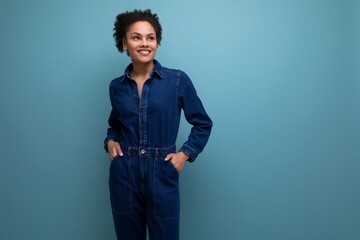 young confident hispanic business woman dressed in blue denim suit over isolated background