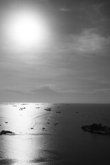 Black and white photo of sea and sky with sunlight or sunset high angle view at Sriracha District of Chonburi Province Can see Koh Loi, Sriracha Port and Ship It is famous tourist attractions