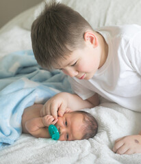 Big brother with his little newborn brother. love family concept