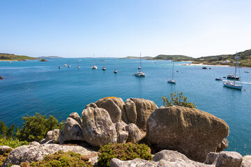 Yachts at anchor in New Grimsby Sound between Tresco and Bryher, Isles of Scilly, UK on a calm Summer's day.  