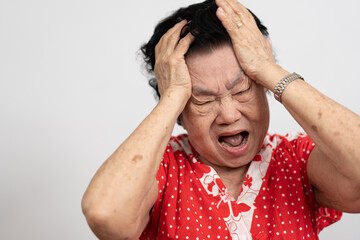 A senior woman who has a severe headache suffers from a stroke ,brain disease,patient holding head...