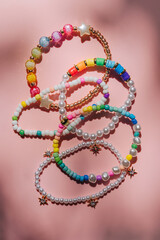 Kids handmade beaded jewelry. Necklaces and bracelets made from multicolored beads and pearls. DIY...