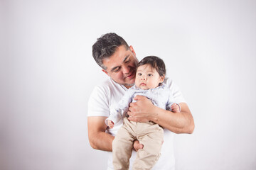 Beautiful photo of dad holding baby on light photo studio background. Family and baby concept.