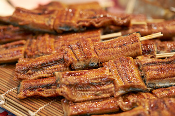 Grilled eel skewers at traditional market