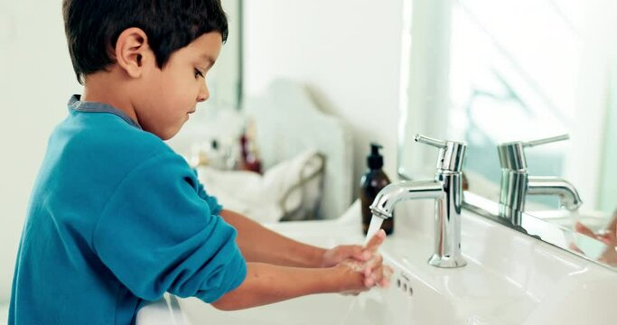 Young boy washing hands, hygiene and health with sustainability, water and routine at home. Male child in bathroom, clean with soap and foam at sink, healthy with handwashing and disinfection