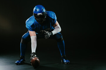 American football player is ready to start the game on a black background.