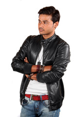 A young handsome Indian guy intently watching someone, on white studio background.