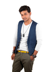 A handsome young Indian guy standing in style, on white studio background