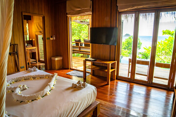 Bedroom inside a cabin on the beach in Haad Tien Beach in shark bay, koh Tao, Thailand