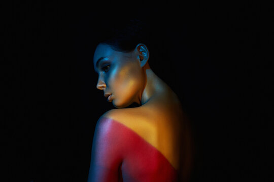 beautiful woman in color lights. Female Back