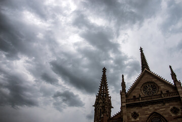 Closeup of protestant temple facade in Mulhouse France on stormy sky background