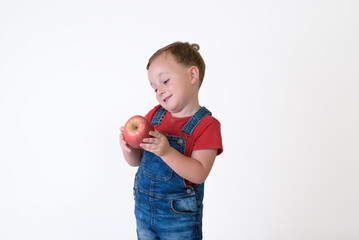 portrait of a girl eating red apple isolated on white. Healthy nutrition. free space