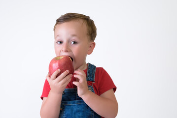 portrait of a girl eating red apple isolated on white. Healthy nutrition. free space