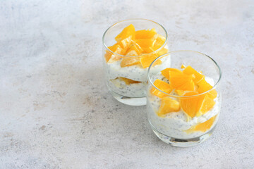 healthy chia pudding with fresh oranges in drinking glasses copy space  