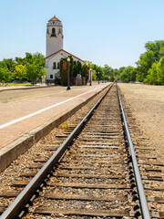 Fototapeta na wymiar Train tracks and depot on a sunny afternoon