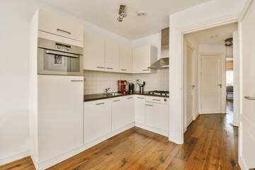 a kitchen with wood flooring and white appliances on the stoves, oven, microwave and dishwasher
