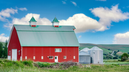 Big beautiful red barn with puffy clouds © knowlesgallery