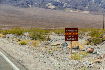 Warning sign caution extreme heat, danger in hot Death Valley National Park, USA