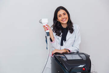 Brazilian, Caucasian woman wearing lab coat, holding laser for body and facial hair removal, laser hair removal. With pistol and machine.