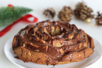 Rose shaped whole wheat plantain cake topped with chocolate sauce.