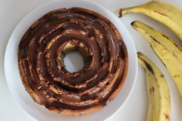 Rose shaped whole wheat plantain cake topped with chocolate sauce.