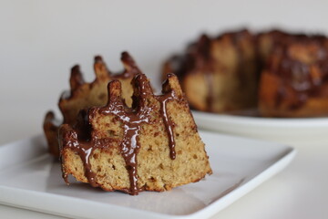 Slices of flower shaped whole wheat plantain cake topped with chocolate sauce