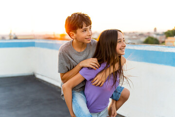 Fototapeta na wymiar Two smiling Caucasian teenagers playing at sunset