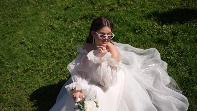 bride sitting on the grass