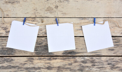 Empty white paper notes on a wooden background