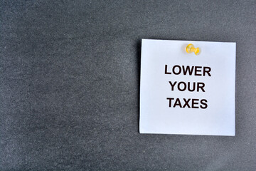Lower your taxes words on a note paper