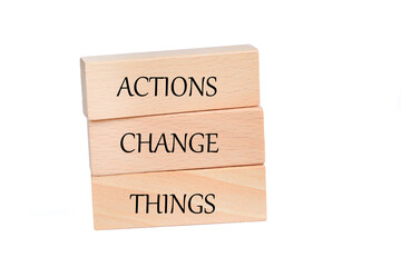 Actions change things words on a wooden blocks
