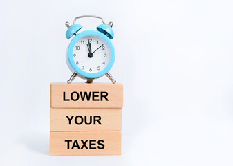 Lower your taxes symbol. Concept words Lower your taxes on wooden blocks