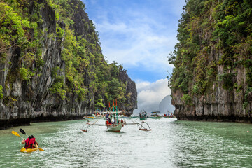 Fototapeta na wymiar Traffic jam with lot of tourist boats in big lagoon. El Nido, Palawan, Philippines