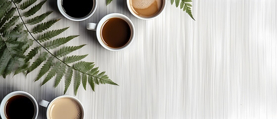 Table top view of coffee cups and compound pinnate leaves.