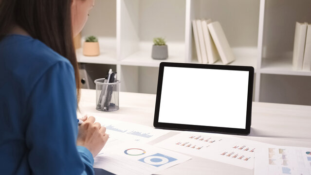 Online conference. Video meeting. Business analyzing. Woman with data statistics charts documents at digital tablet with empty space white mockup screen at office workspace. - Powered by Adobe