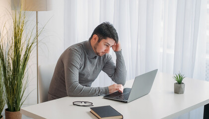 Work pressure. Exhausted employee. Job burnout. Tired weary unhappy business man stressed with deadline overwork lack of sleep at laptop modern office desk.