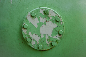 Obraz na płótnie Canvas Old metal steel Pressure Cap of Gas Tank Reservoir in Factory with radial Bolts and green chipped away paint with rust on gray primer. Flat front texture